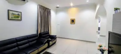 a living room with a black leather couch at 18pax Bungalow Homestay Hutan Melintang in Hutan Melintang
