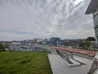 a view of a city with a street with cars at Cozy City Stay at Kuching Prime location in Gua Sai