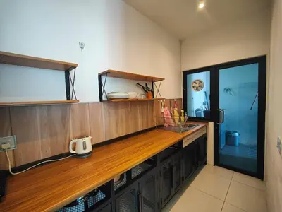 a large wooden counter in a room with a tv at Cozy City Stay at Kuching Prime location in Gua Sai