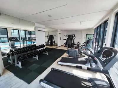 a gym with treadmills and exercise machines in it at Cozy City Stay at Kuching Prime location in Gua Sai