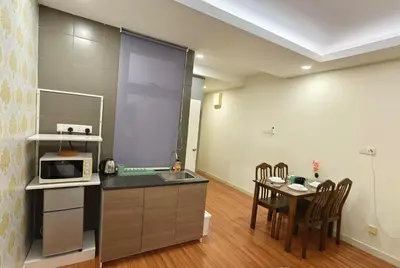 a kitchen and dining room with a table and a microwave at JJ's Modern Suite Kampar- Near UTAR in Kampar
