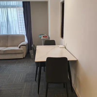 a room with a table and chairs and a couch at Kuala Lumpur Residence At Hotel Times square in Gua Sai