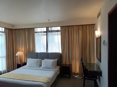 a hotel room with a bed and a desk and window at Kuala Lumpur Residence At Hotel Times square in Gua Sai