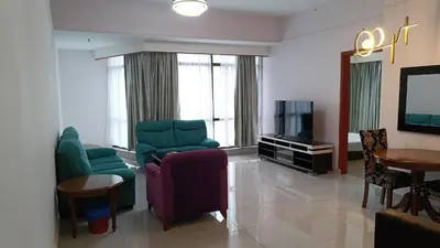 a living room with a couch and chairs and a tv at Kuala Lumpur Residence At Hotel Times square in Gua Sai