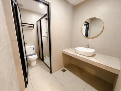a bathroom with a sink and a mirror and a toilet at Resandau Stay Ipoh - Nearby Ipoh Town - Private Car Park and Lift - Whole unit & Coliving in Ipoh
