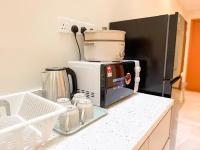 a coffee maker sitting on top of a microwave at Resandau Stay Ipoh - Nearby Ipoh Town - Private Car Park and Lift - Whole unit & Coliving in Ipoh