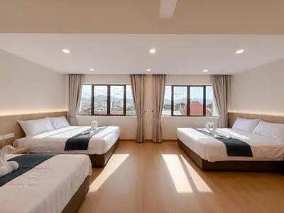 two beds in a room with two windows at Resandau Stay Ipoh - Nearby Ipoh Town - Private Car Park and Lift - Whole unit & Coliving in Ipoh