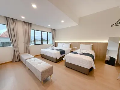 a hotel room with two beds and a couch at Resandau Stay Ipoh - Nearby Ipoh Town - Private Car Park and Lift - Whole unit & Coliving in Ipoh