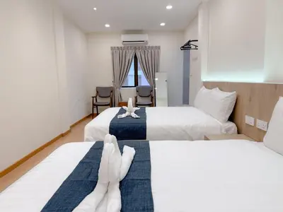 two beds in a hotel room with towels on them at Resandau Stay Ipoh - Nearby Ipoh Town - Private Car Park and Lift - Whole unit & Coliving in Ipoh