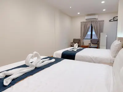 two towels on two beds in a hotel room at Resandau Stay Ipoh - Nearby Ipoh Town - Private Car Park and Lift - Whole unit & Coliving in Ipoh