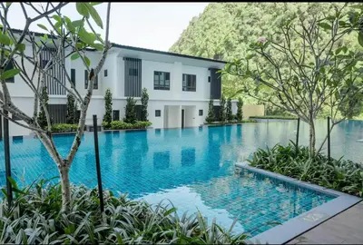 a swimming pool in front of a building at Theme Park Ipoh - Onsen Premier Suites By LUX SUITE in Ipoh