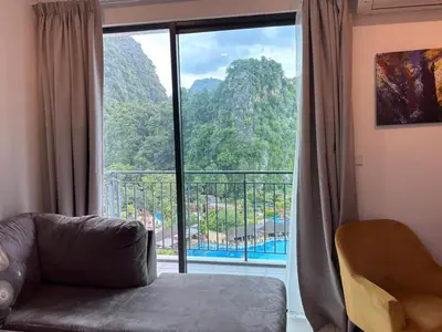 a living room with a large window with a view at Theme Park Ipoh - Onsen Premier Suites By LUX SUITE in Ipoh