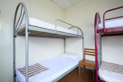 a room with two bunk beds and a chair at Ros Heritage Motel in George Town