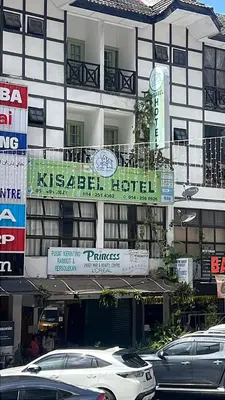 a building with cars parked in front of it at KISABEL Budget Hotel in Tanah Rata