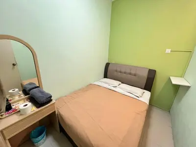 a small room with a small bed and a mirror at KISABEL Budget Hotel in Tanah Rata