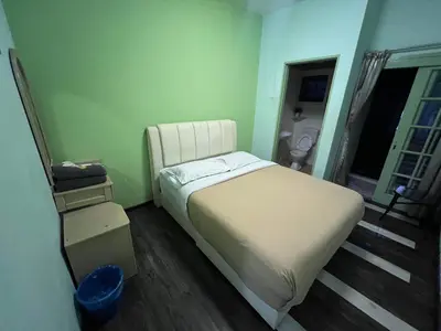 a small bedroom with a bed and a window at KISABEL Budget Hotel in Tanah Rata