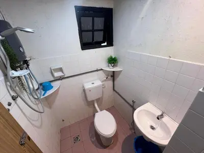 a bathroom with a toilet and a sink at KISABEL Budget Hotel in Tanah Rata