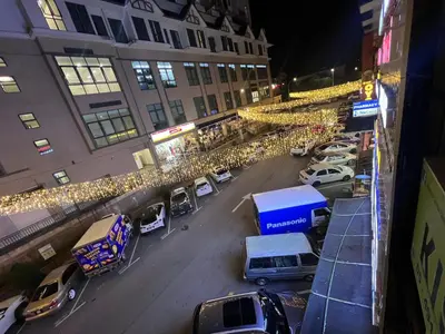 a city street with cars parked in front of buildings at KISABEL Budget Hotel in Tanah Rata