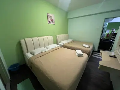 a hotel room with two beds and a television at KISABEL Budget Hotel in Tanah Rata