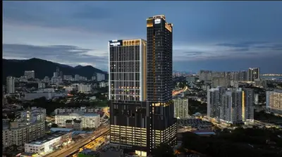 a tall building with lights on in a city at Wanderlust Retreat Studio by Iconic Regency in Bayan Lepas