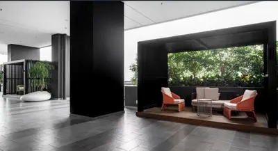 a living room with a couch and chairs in a building at Wanderlust Retreat Studio by Iconic Regency in Bayan Lepas