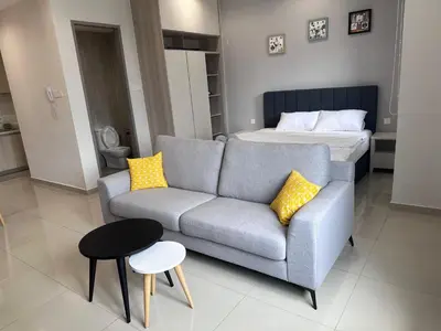 a living room with a couch and a bed at Wanderlust Retreat Studio by Iconic Regency in Bayan Lepas