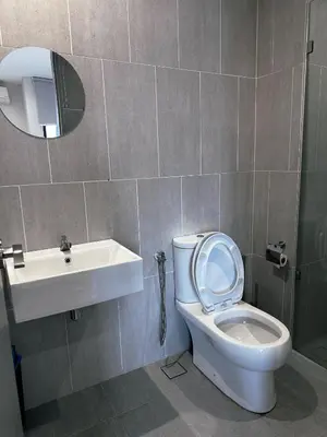 a bathroom with a toilet and a sink and a mirror at Wanderlust Retreat Studio by Iconic Regency in Bayan Lepas