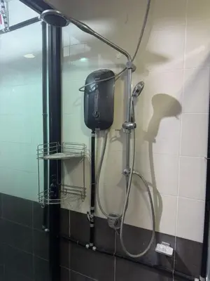 a shower in a bathroom with a shower head at home sweet home in Kampong Batu Maung