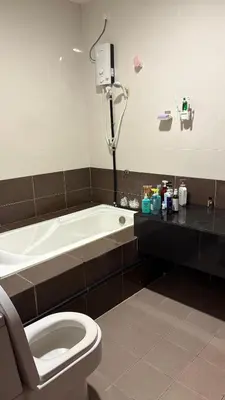 a bathroom with a toilet and a bath tub at home sweet home in Kampong Batu Maung