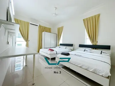 a bedroom with two beds and a desk in it at Penang 6BR ART CONCEPT Friends & Family Villa in Balik Pulau