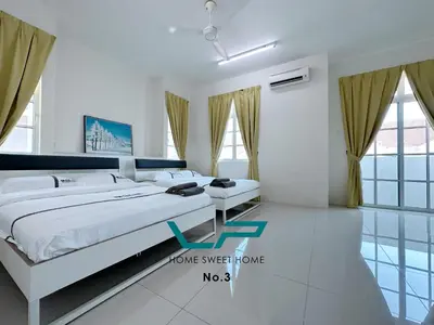 a bedroom with a large white bed and windows at Penang 6BR ART CONCEPT Friends & Family Villa in Balik Pulau