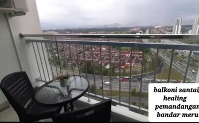 a balcony with a table and a chair and a street at D'PrimaVerra in Ipoh