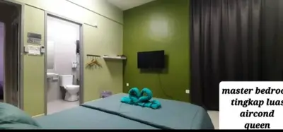 a bedroom with a bed with a blue bow on it at D'PrimaVerra in Ipoh