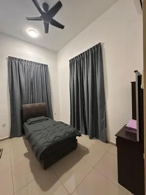 a bedroom with a bed and a ceiling fan at Xiang Homestay in Padang Serai