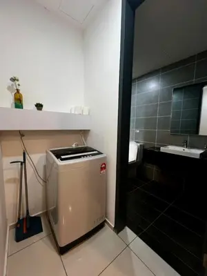 a small bathroom with a sink and a small refrigerator at Sunway Onsen Ipoh by EUcation Home in Tambun