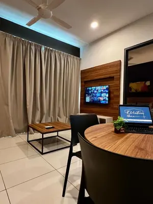 a dining room with a table with a laptop on it at Sunway Onsen Ipoh by EUcation Home in Tambun
