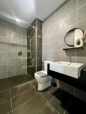 a bathroom with a toilet and a sink and a shower at Sunway Onsen Ipoh by EUcation Home in Tambun