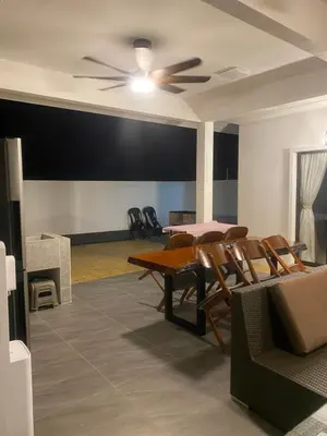a dining room with a ceiling fan and a table and chairs at Untung5tay in Gua Sai