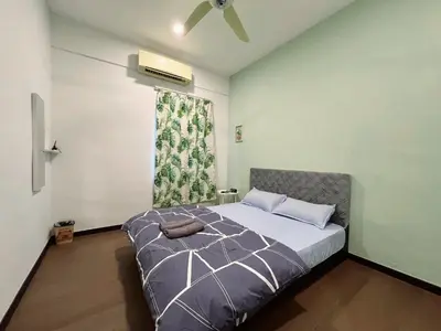 a bedroom with a bed with a fan and a window at Modern Casual Style Haus 4Room`````Alma in Bukit Mertajam