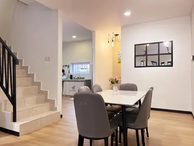 a dining room with a table and chairs and a staircase at Modern Casual Style Haus 4Room`````Alma in Bukit Mertajam