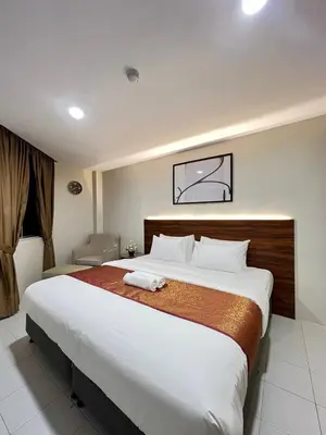 a bedroom with a large bed in a hotel room at Hotel Istanaku , Ipoh, Perak in Ipoh