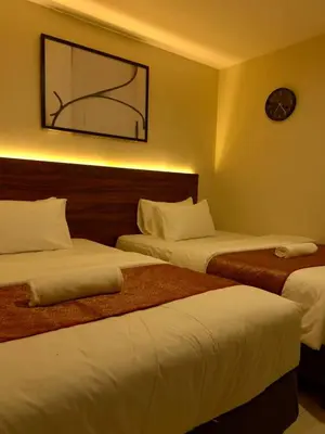 a hotel room with two beds and a picture on the wall at Hotel Istanaku , Ipoh, Perak in Ipoh