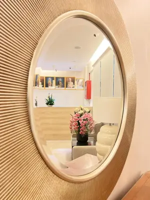 a round mirror on a wall in a living room at Hotel Istanaku , Ipoh, Perak in Ipoh