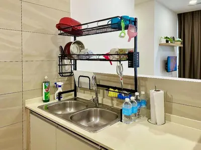 a kitchen sink with a dish drying rack above it at #2 Hann's Residence Homestay Sunset View 2R2B in Gua Sai