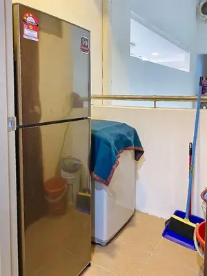 a refrigerator in a kitchen with a blue towel on it at #2 Hann's Residence Homestay Sunset View 2R2B in Gua Sai