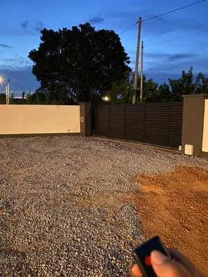 a person holding a remote control in front of a fence at Untung5tay in Gua Sai