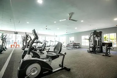 a gym with several treadmills and exercise bikes in it at Ipoh Manhattan Waterpark Suite by City Home Empire MHA306 in Ipoh