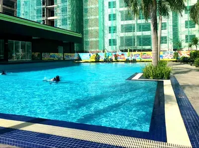 a person swimming in a swimming pool in a building at Ipoh Manhattan Waterpark Suite by City Home Empire MHA306 in Ipoh