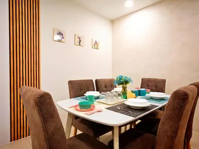a dining room with a white table and chairs at Ipoh Manhattan Waterpark Suite by City Home Empire MHA306 in Ipoh