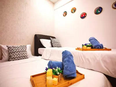 a room with two beds with shoes on them at Ipoh Manhattan Waterpark Suite by City Home Empire MHA306 in Ipoh